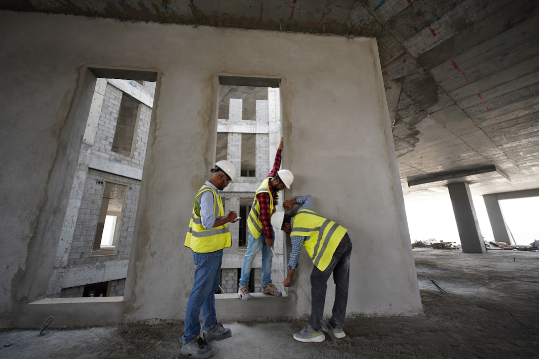 obra de construção civil com engenheiro conferindo projeto